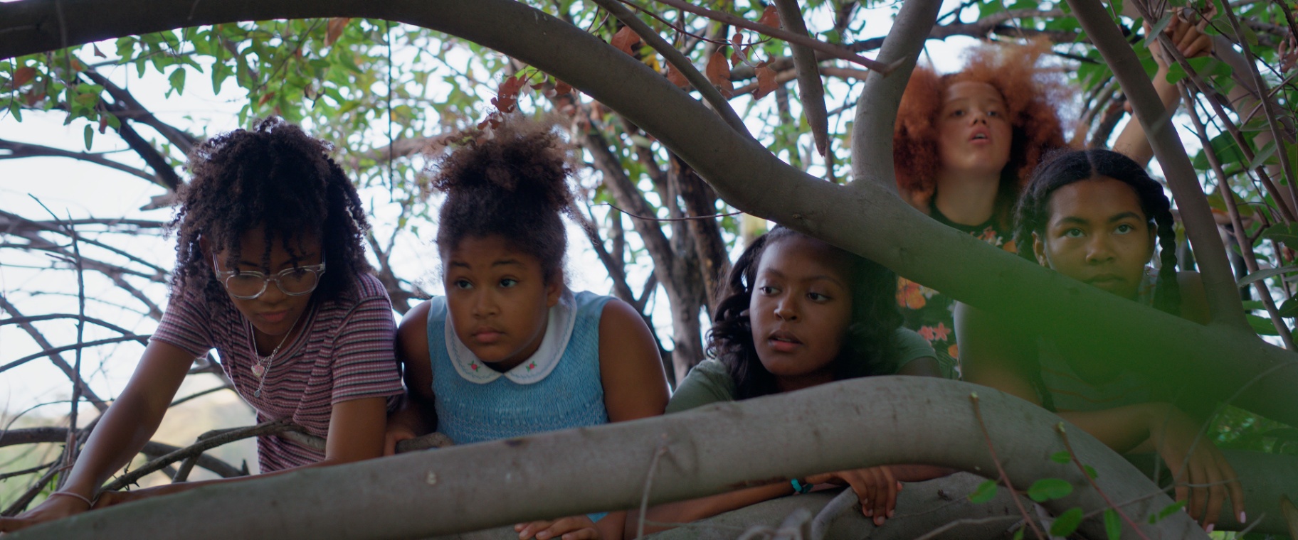 Still from Brownies: a quiet moment between Brownie troop members at summer camp, captured in warm naturalistic light